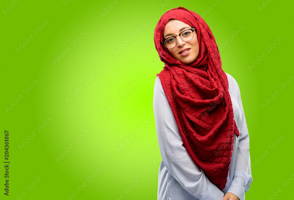 Young arab woman wearing hijab confident and happy with a big natural smile laughing, natural expression Young arab woman wearing hijab confident and happy with a big natural smile laughing, natural expression