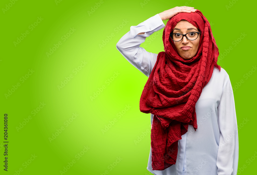 Young arab woman wearing hijab doubt expression, confuse and wonder concept, uncertain future Young arab woman wearing hijab doubt expression, confuse and wonder concept, uncertain future