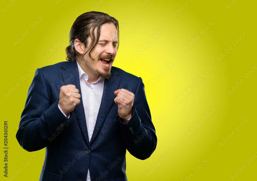 Handsome young man happy and surprised cheering expressing wow gesture Handsome young man happy and surprised cheering expressing wow gesture