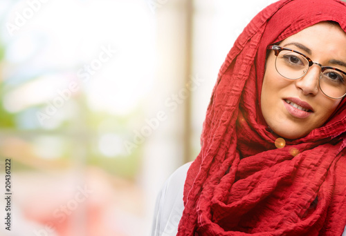 Young arab woman wearing hijab confident and happy with a big natural smile laughing, natural expression