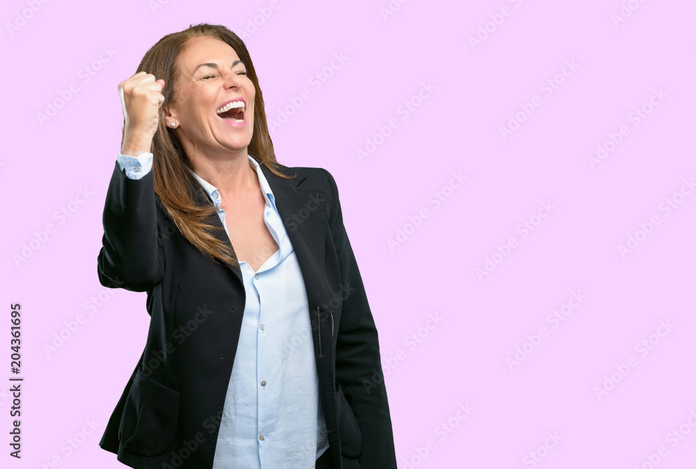 Middle age business woman happy and excited expressing winning gesture. Successful and celebrating victory, triumphant Middle age business woman happy and excited expressing winning gesture. Successful and celebrating victory, triumphant