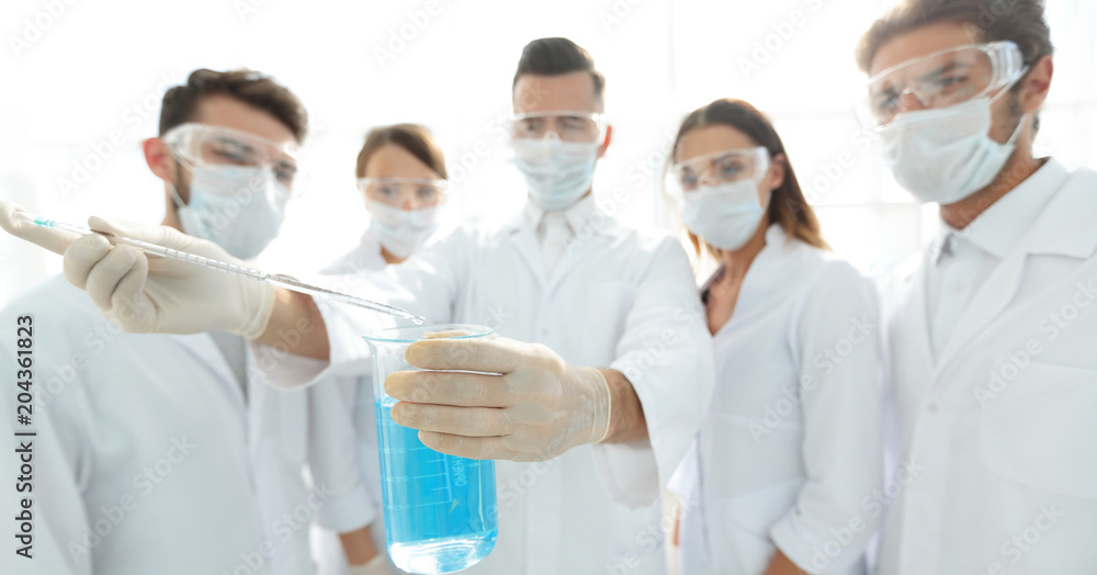 closeup of a group of medical workers working with liquids closeup of a group of medical workers working with liquids