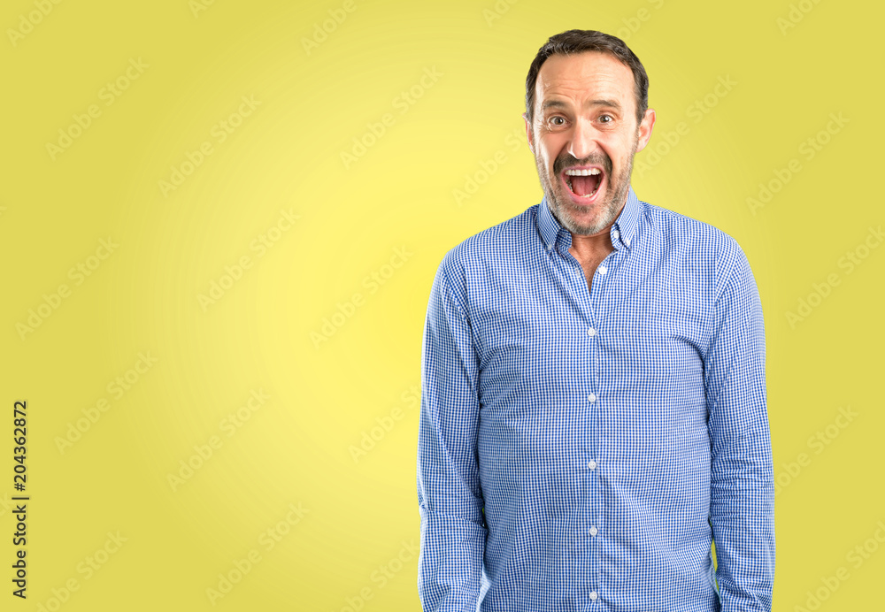 Handsome middle age man happy and surprised cheering expressing wow gesture Handsome middle age man happy and surprised cheering expressing wow gesture