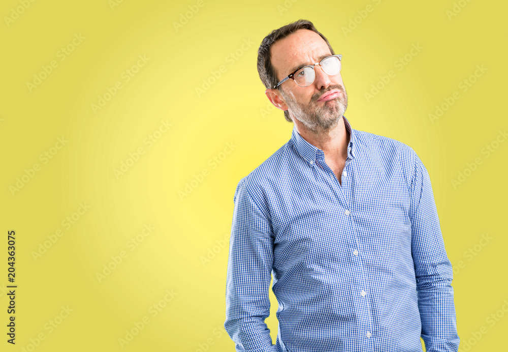 Handsome middle age man with sleepy expression, being overworked and tired Handsome middle age man with sleepy expression, being overworked and tired