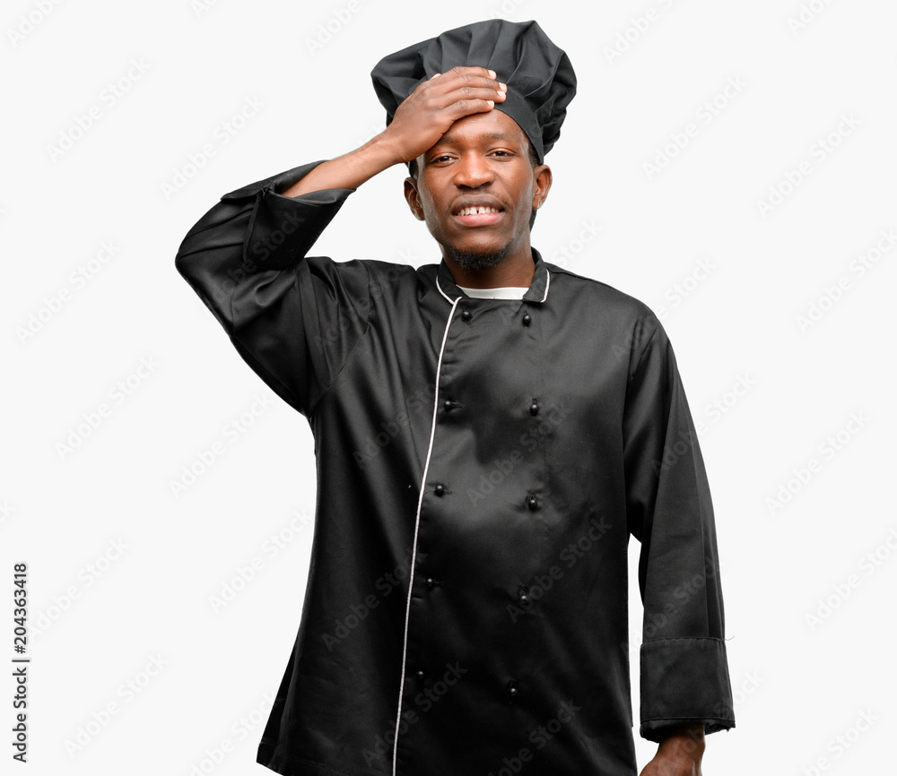 Young black cook wearing chef hat terrified and nervous expressing anxiety and panic gesture, overwhelmed Young black cook wearing chef hat terrified and nervous expressing anxiety and panic gesture, overwhelmed