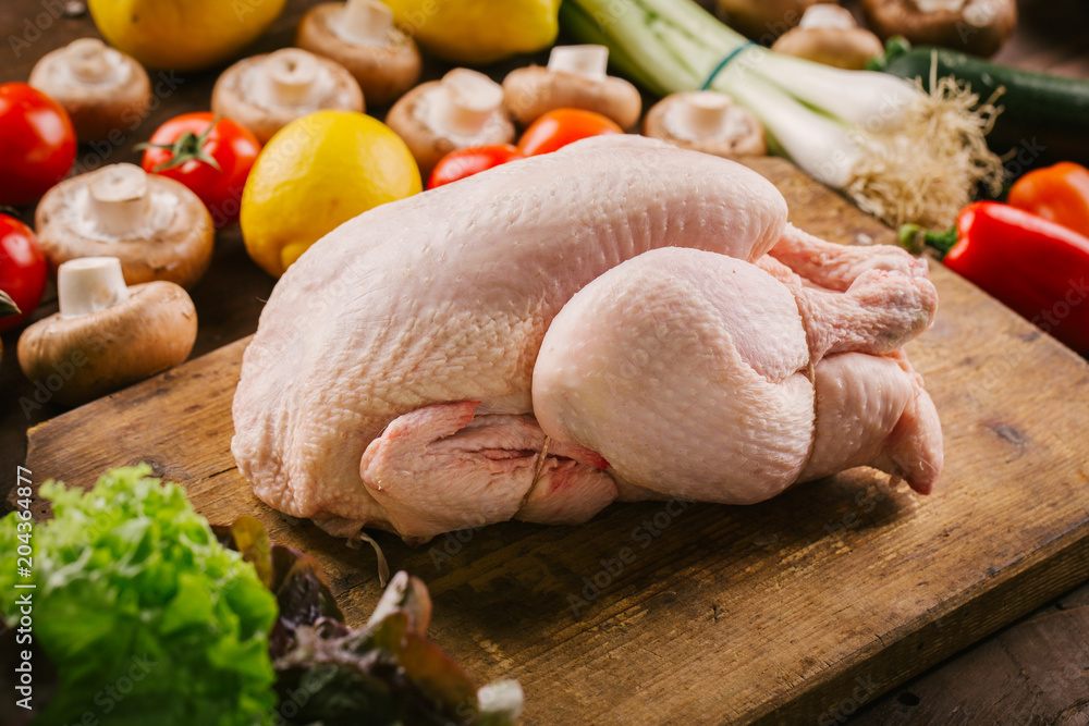 Fresh poultry chicken on wooden table ready to cook Fresh poultry chicken on wooden table ready to cook