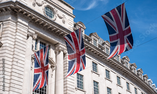 Close up of buildings on Regent Street London UK photographed from street level, with row of British flags to celebrate the Royal Wedding of Prince Harry to Meghan Markle.