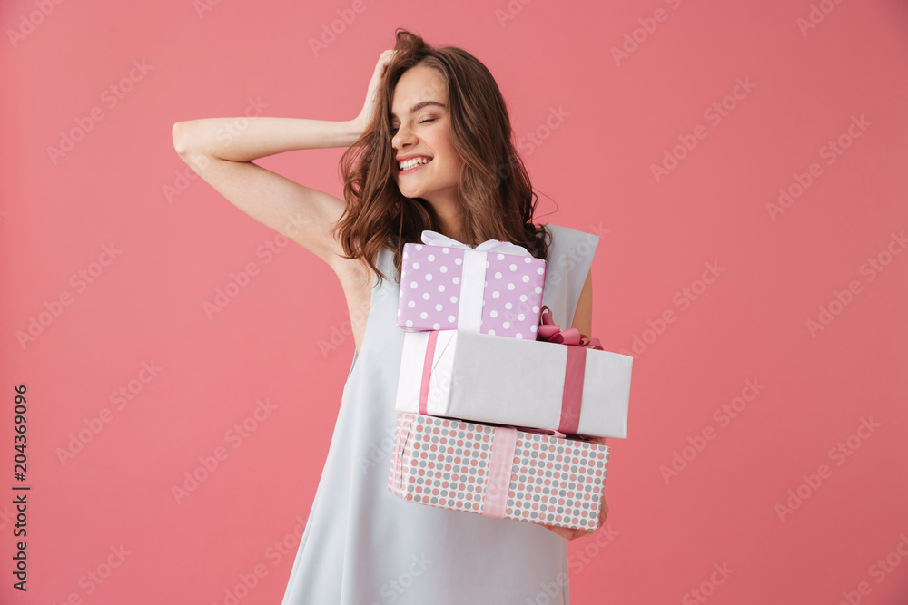 Cute excited young woman holding gift present surprise. Cute excited young woman holding gift present surprise.