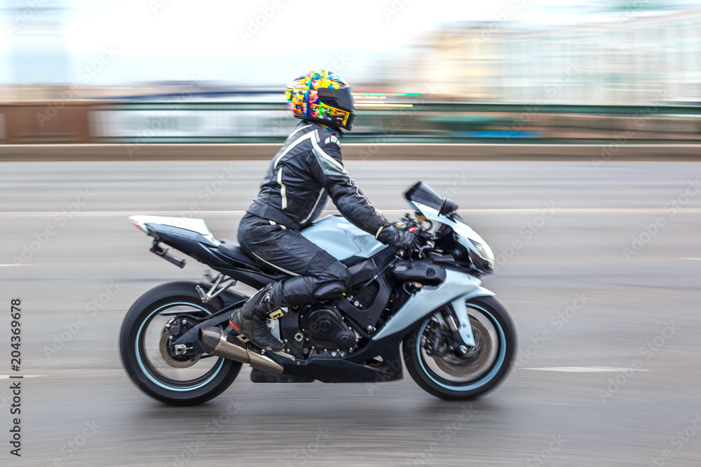 motorcyclist in motion on the road at speed
