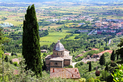 Cortona, Italy. Panoramic view of the tuscany countryside with cypres and the church of Santa Maria delle Grazie al Calcinaio.
