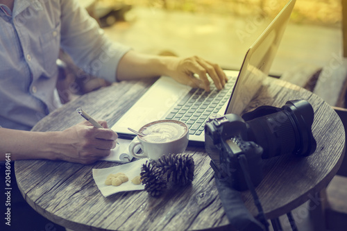 Man  working on laptop in an outdoor cafe. photo