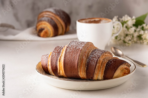 Fresh croissants. French pastries. Breakfast with croissants and tea, coffee.