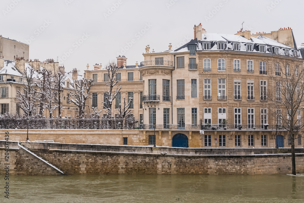 Paris under the snow and floods, flooded quays, typcal staircase, the Seine in winter 
