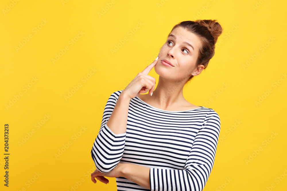 Woman against yellow wall background Woman against yellow wall background