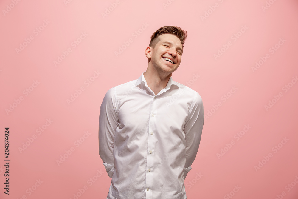 Obraz premium The happy business man standing and smiling against pink background.