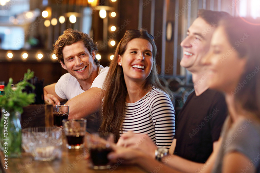 Group Of Friends Enjoying Meal In Restaurant