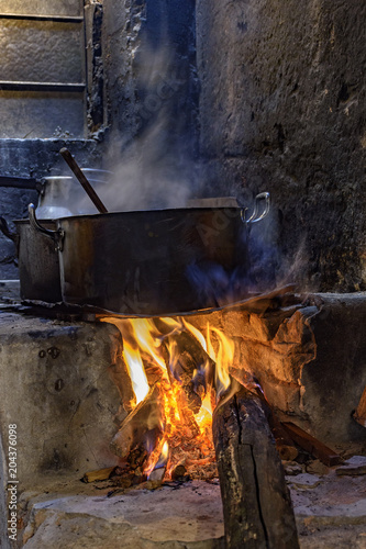 Traditional Brazilian food being prepared on old and popular wood stove