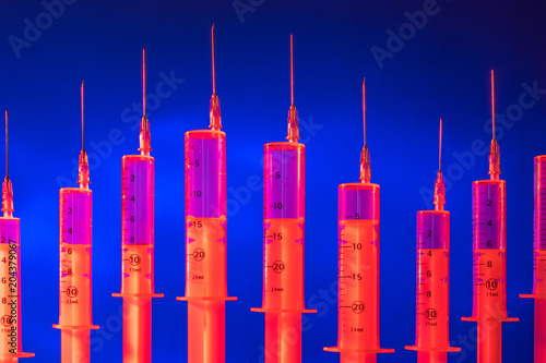 Syringes of red color. Medi...
