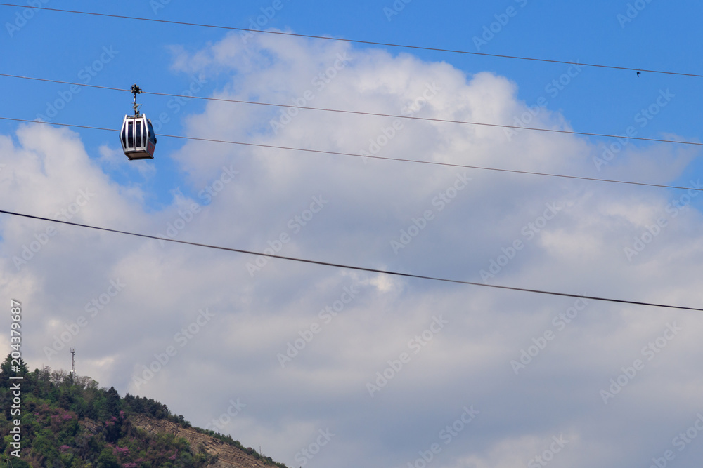 Cabin of the cable car against blue sky. Cableway in Tbilisi, Georgia