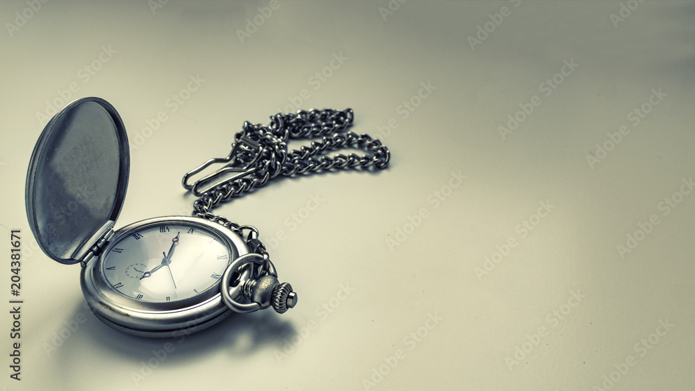 Photograph of antique clock with chain.
