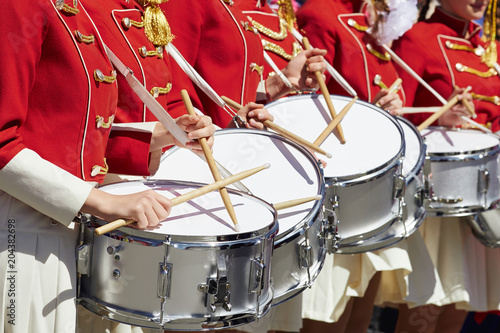 Konstfotografi Closeup of group of girls of fans in red military uniform with drums