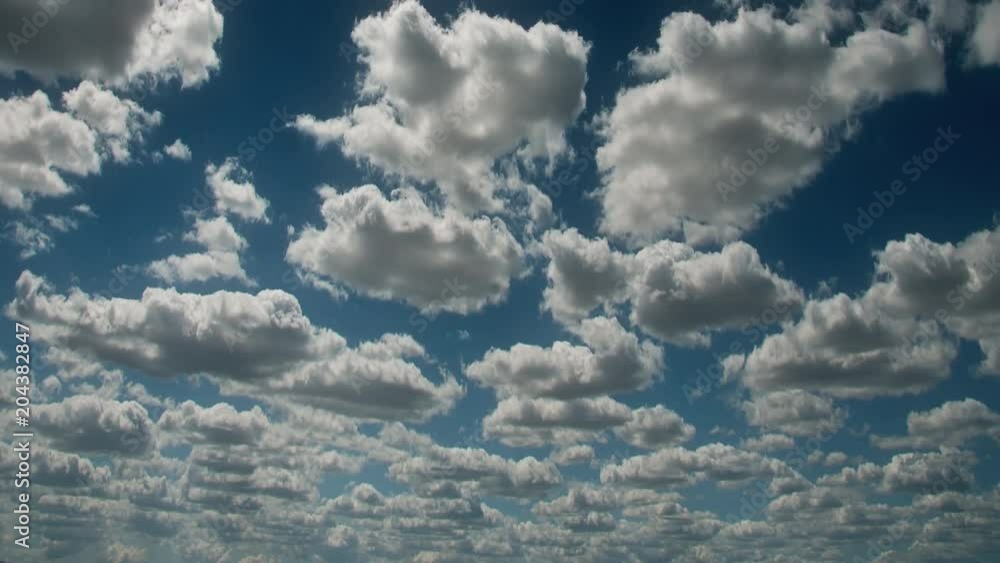Time lapse clouds travel across a blue sky. Time lapse clouds travel across a blue sky.