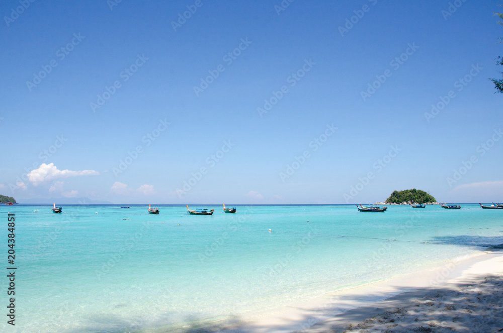 Turquoise sea And blue sky White Sand Beach with taxi long tail boat, travel concept. Koh Lipe, Satun, Thailand