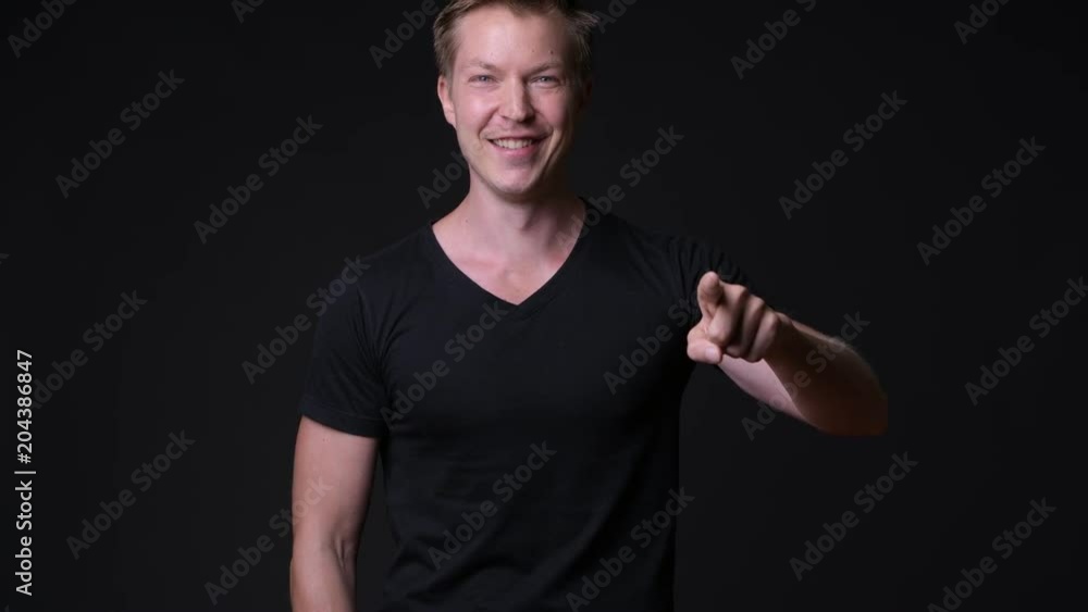 Young handsome man against black background Young handsome man against black background