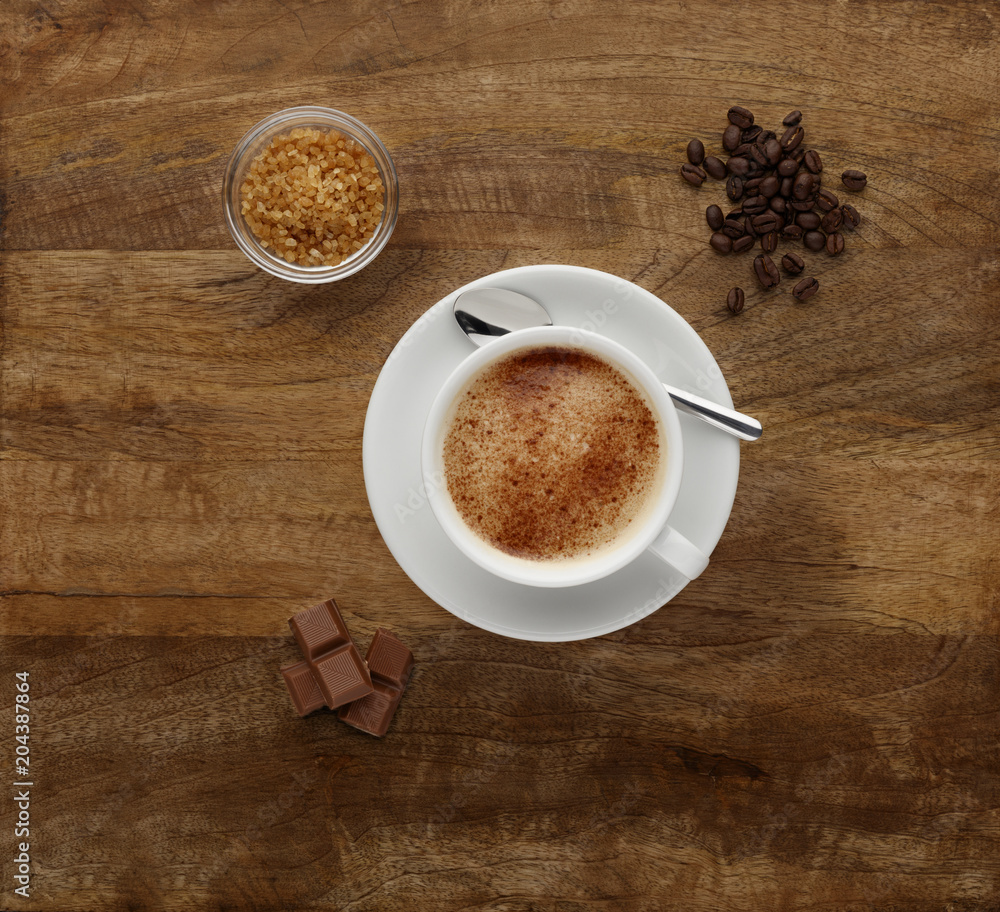 A Mocha coffee, shot on a wooden worktop, with coffee beans and chocolate. A Mocha coffee, shot on a wooden worktop, with coffee beans and chocolate.