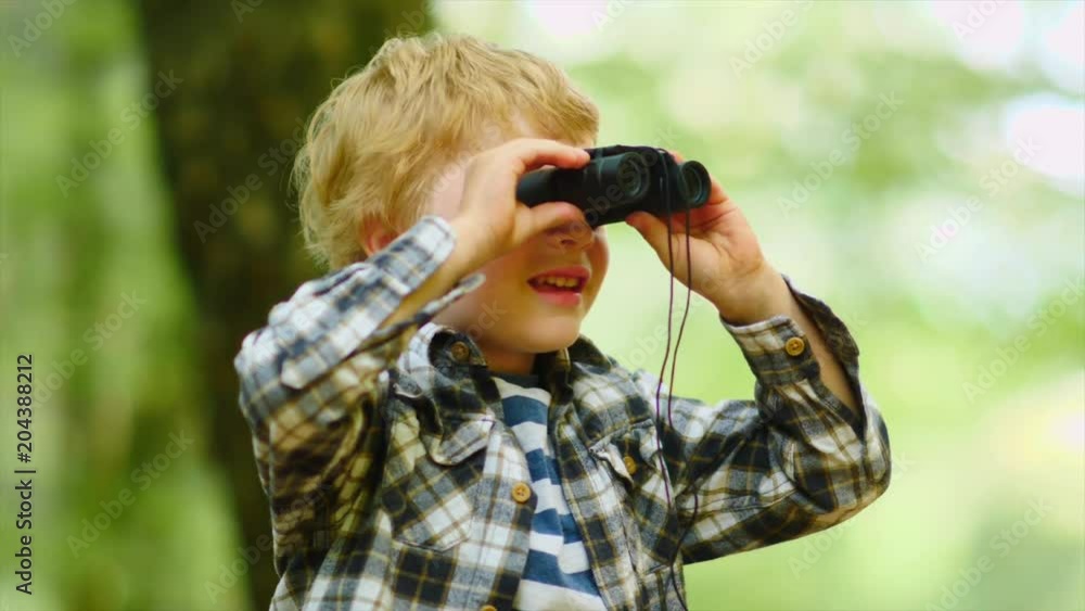 Boy Looking Through Binoculars In Woods Boy Looking Through Binoculars In Woods