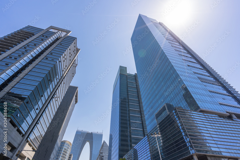 up view of modern glass building in urban up view of modern glass building in urban