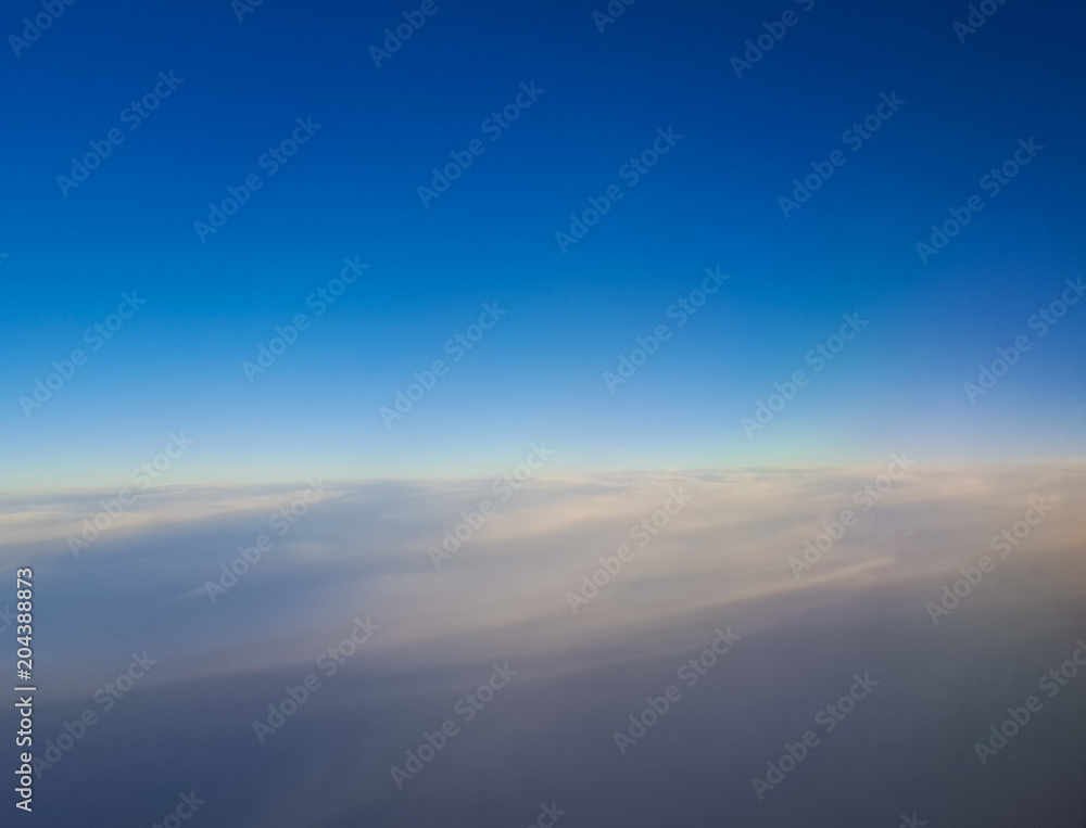 Fototapeta premium View from airplane window, clouds like carpet.