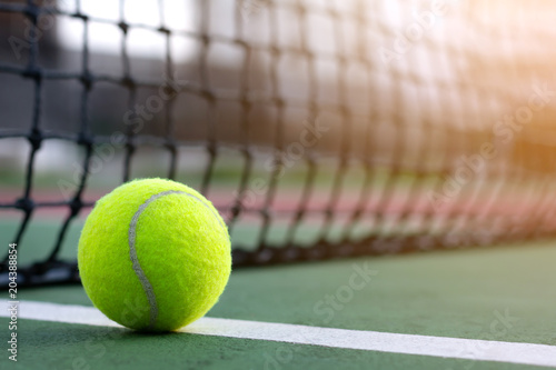 Close up tennis ball on blur net with copy space