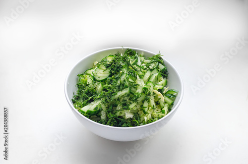salad from cabbage, cucumbers, dill