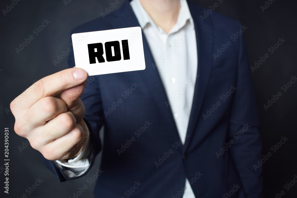 Businessman shows business card with the inscription:ROI Businessman shows business card with the inscription:ROI