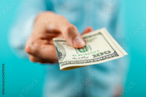 Man holding a hundred dollar bill