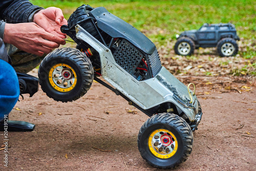 Man is holding Radio-controlled car