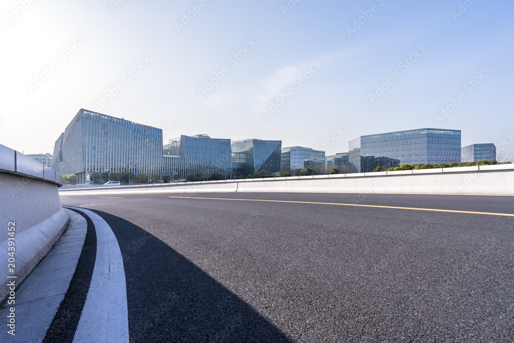 empty road with modern office building empty road with modern office building