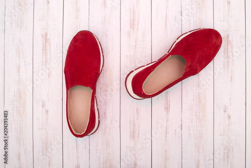 Red Women's sneakers on a wooden background