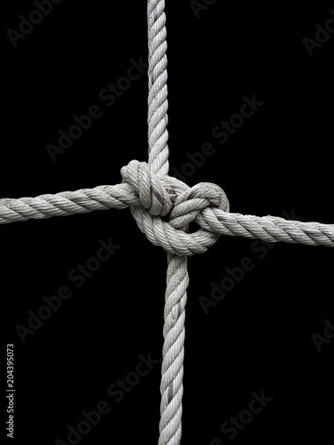 Rope knot on black background. Concept for unity