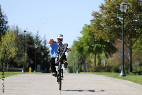 Fototapeta Naklejka Na Ścianę i Meble -  Man doing a wheelie on a bicycle.