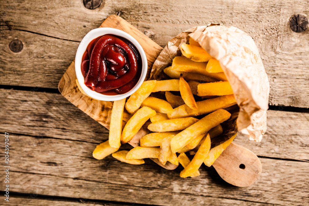 French fries on wooden table French fries on wooden table