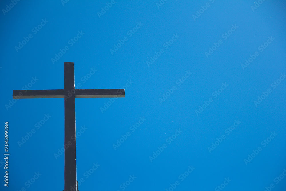 The Old wooden cross with the blue sky background. The Old wooden cross with the blue sky background.