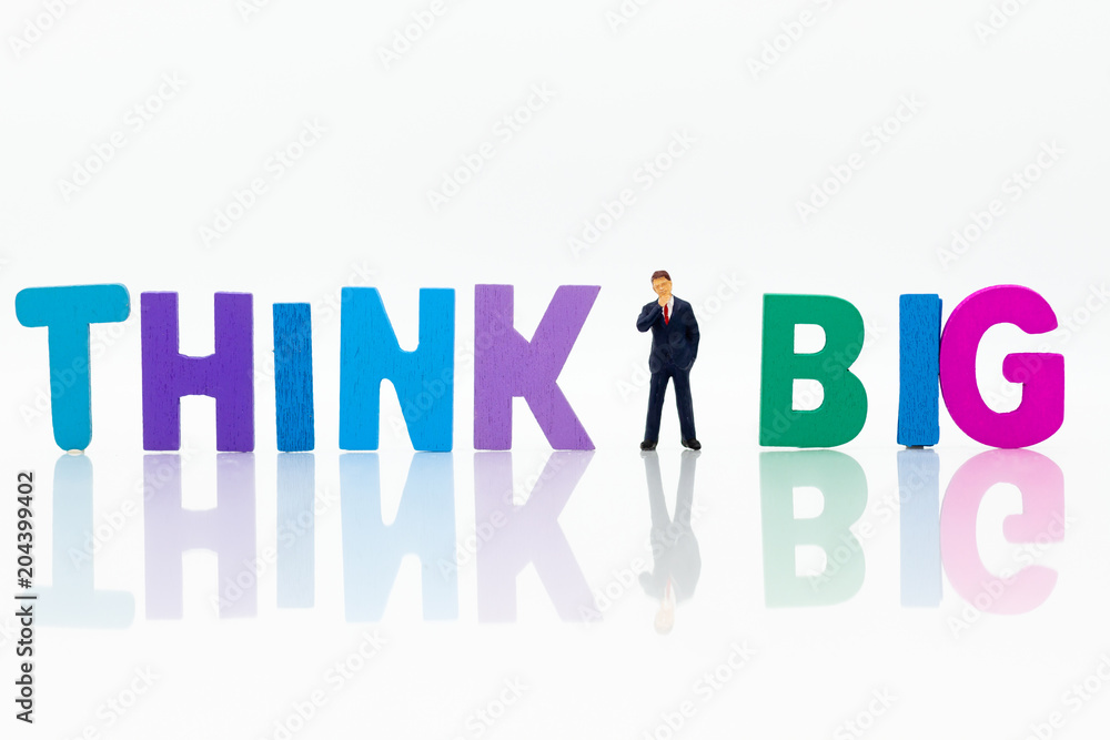 Miniature people: Businessman with text THINK BIG. Image use for idea,, business concept. Miniature people: Businessman with text THINK BIG. Image use for idea,, business concept.
