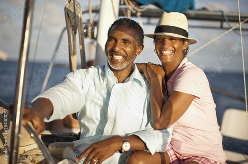 Mature couple enjoying the sun and view from boat deck.