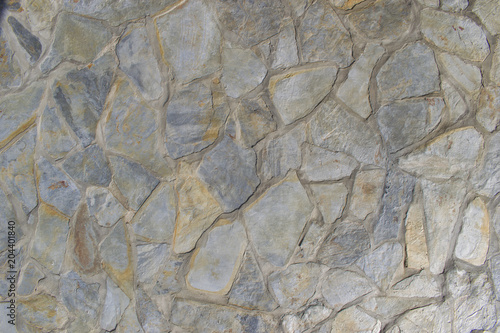 Grey stone wall background. Mosaic stone texture.