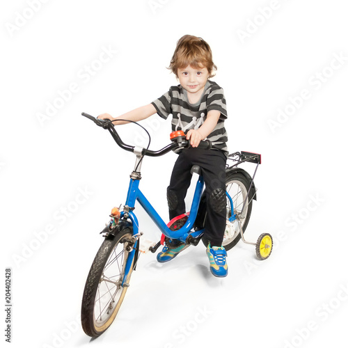 Happy little boy on bike isolated on white