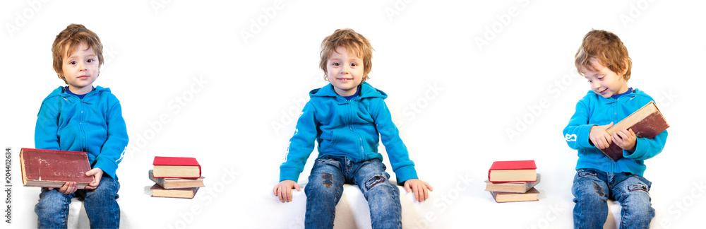 A little child of three years is interested in books. Isolated on a white background A little child of three years is interested in books. Isolated on a white background