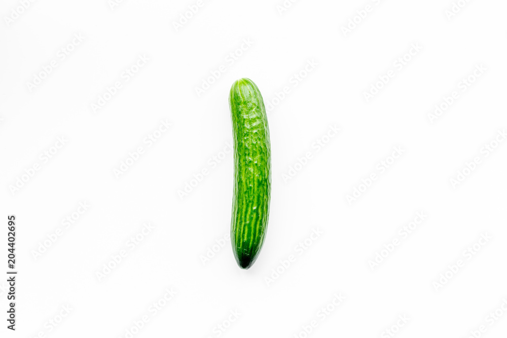 Single whole cucumber on white background top view copy space Single whole cucumber on white background top view copy space