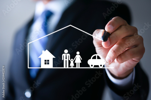 Businessman drawing protective and car, family, life and health insurance icons. Insurance concept.